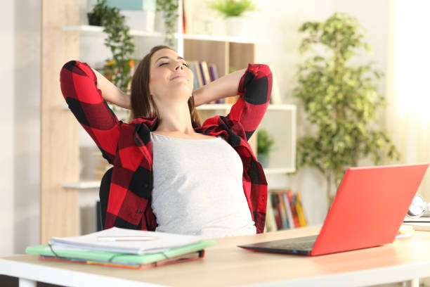 istock Student with laptop relaxing satisfied at home 1227181288