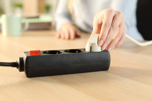 istock Woman hand plugging plug on a power strip socket 1227181365