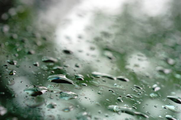 Water drops of rain on car glass