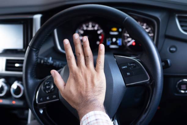 istock Man is honking car horn for safety 1227183626