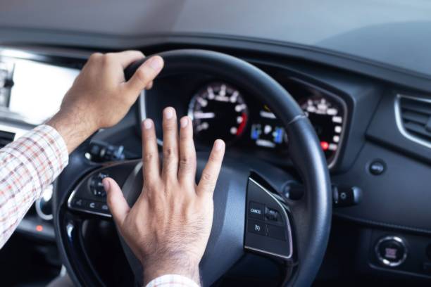 istock Man honking car horn for safety 1227184327