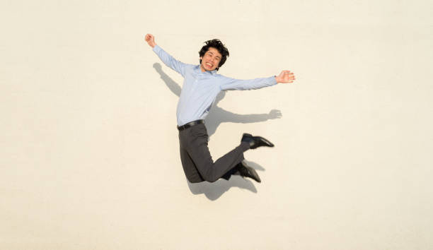 A happy man expresses joy with a whole body jump A happy man expresses joy by jumping with his whole body.
Millennial Japanese man. A smart casual shirt and slacks. comedian photos stock pictures, royalty-free photos & images