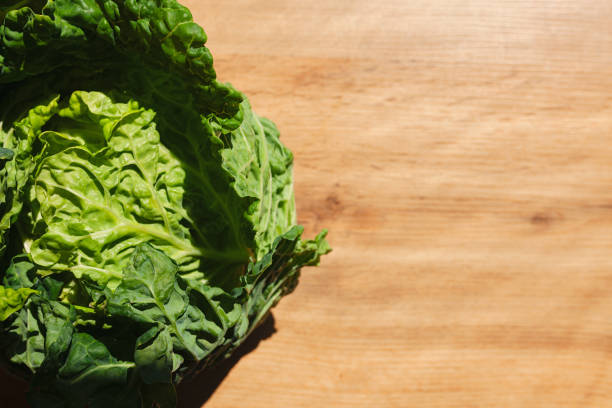 istock Head of kale on wooden table under the sunlight, with copy space 1227188395