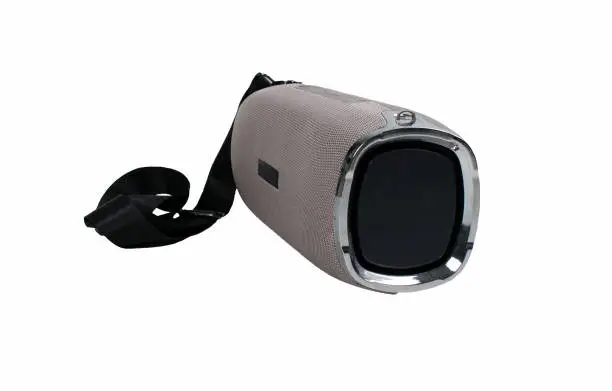Portable grey speaker with the removable soft handle. Connect with smartphone or pc to play the music. Close up,