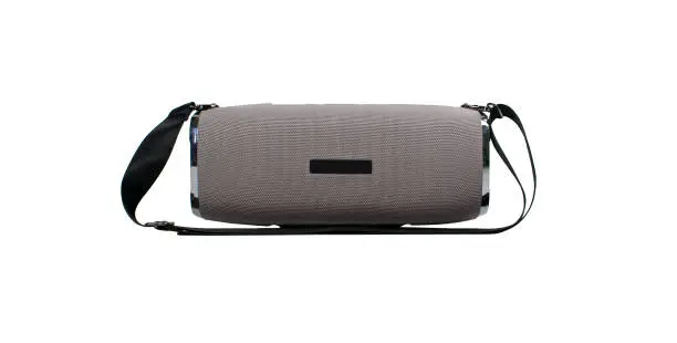 Portable grey speaker with the removable soft handle. Connect with smartphone or pc to play the music. Close up,
