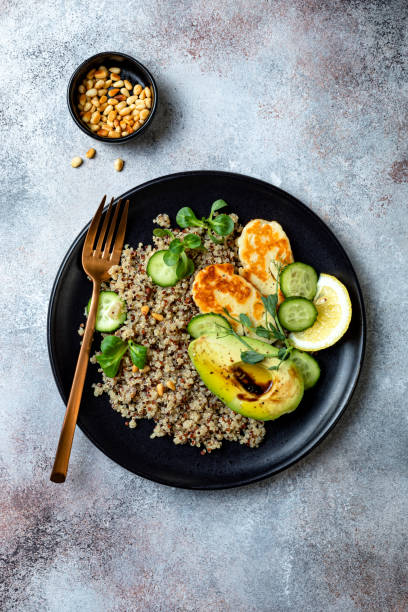 istock Grilled Halloumi cheese salad with quinoa, avocado, cucumber, toasted pine nuts dressed with honey balsamic vinaigrette. Healthy vegetarian dinner 1227191898