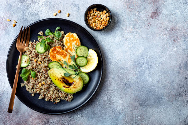 istock Grilled Halloumi cheese salad with quinoa, avocado, cucumber, toasted pine nuts dressed with honey balsamic vinaigrette. Healthy vegetarian dinner 1227191908