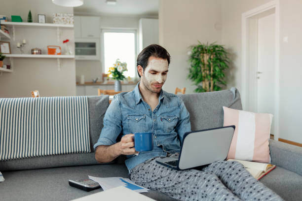 Nothing pleasures me more than my job Casual Young Businessman Working From Home With Treatment Mud Applied on His Face. Freelancer, Entrepreneur Works at Home. Distance Work, Online Education. lifehack stock pictures, royalty-free photos & images