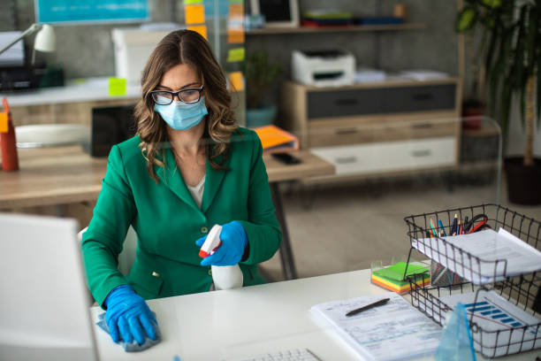 istock Businesswoman disinfecting work place 1227193701
