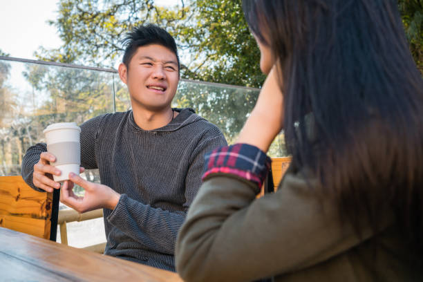 istock Asian couple at coffee shop. 1227193920