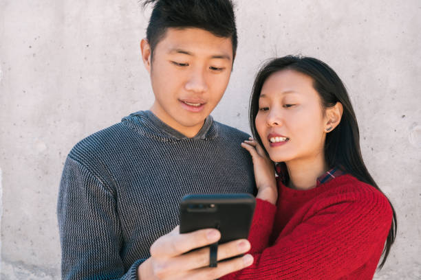 istock Asian couple looking at the mobile phone. 1227193931
