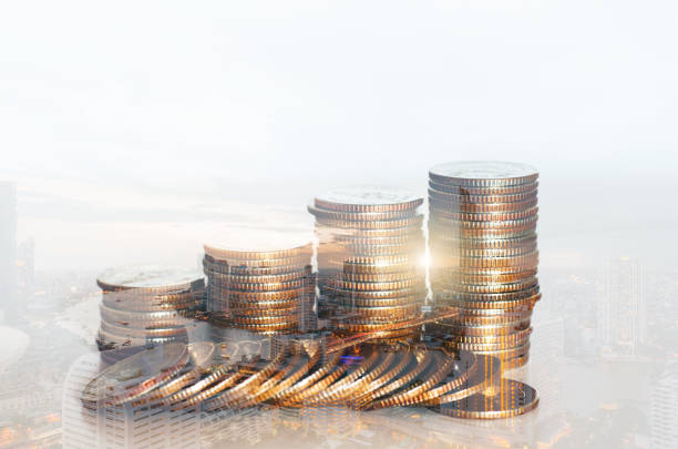 istock double exposure of city with row of coin stack with growth chart and graph progress report for business investment finance banking and money saving concept. 1227194762