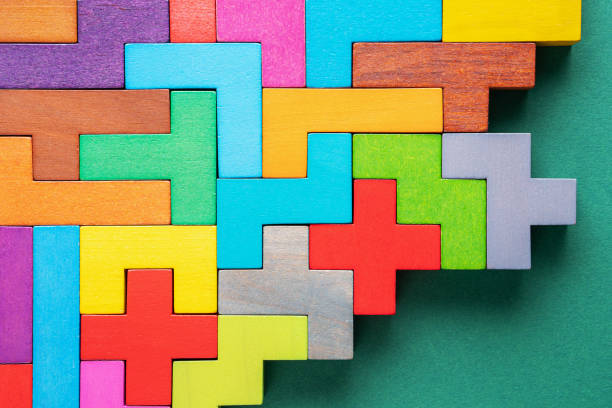 istock Different colorful shapes wooden blocks on green background, flat lay. 1227194803