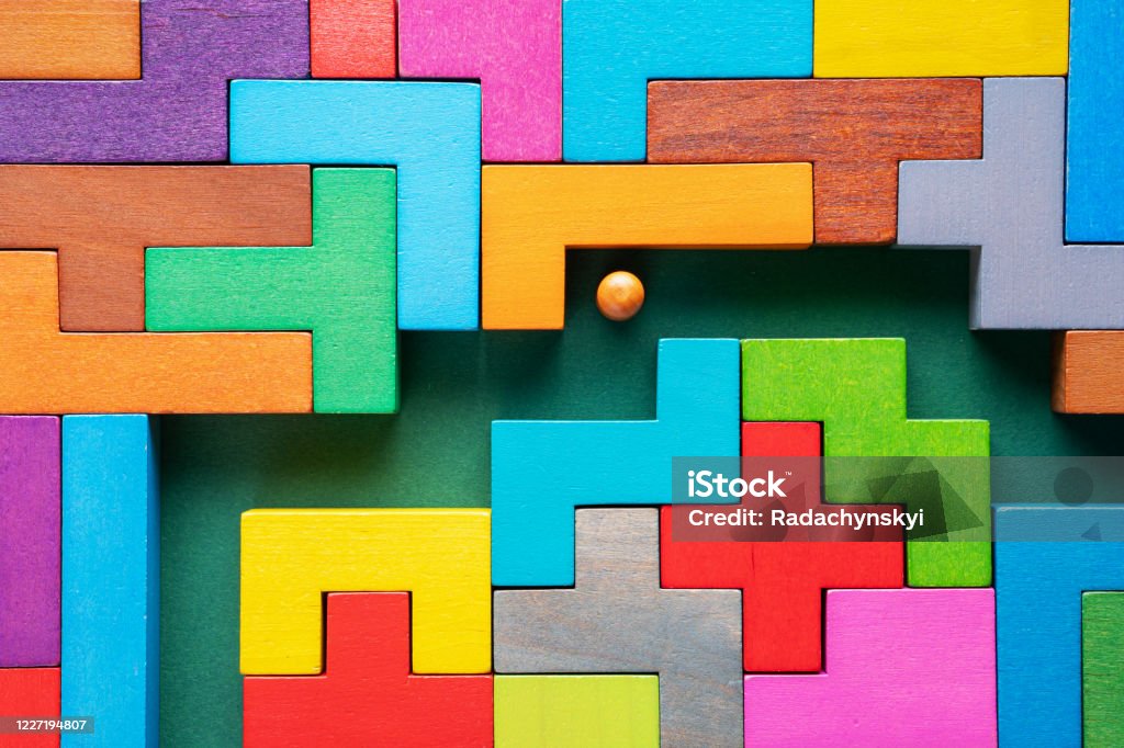 The concept of a business strategy, analytics, search for solutions, the search output. Labyrinth of colorful wooden blocks. The concept of a business strategy, analytics, search for solutions, the search output. Labyrinth of colorful wooden blocks. People in the maze, finding a way out. The man in the maze. Solution Stock Photo