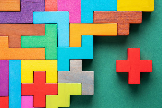 istock Different colorful shapes wooden blocks on green background, flat lay. 1227194834