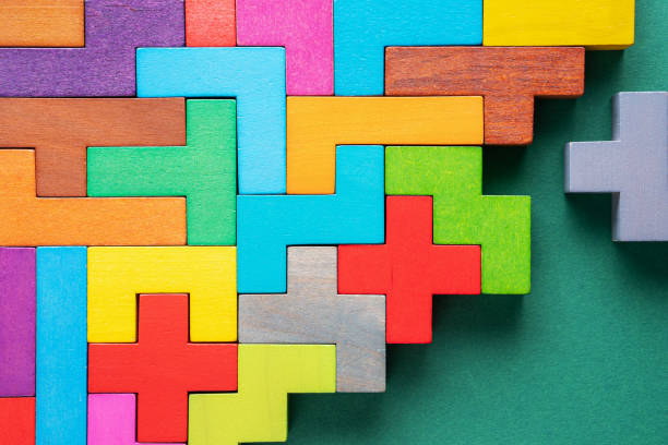 istock Different colorful shapes wooden blocks on green background, flat lay. 1227194862