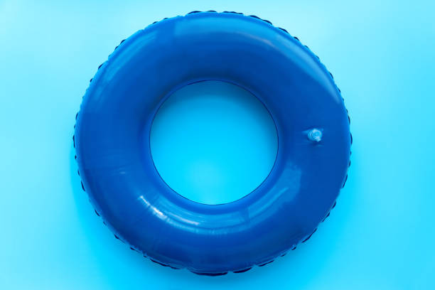 istock Front view of blue rubber ring for swimming pool on blue background. Top view 1227195916