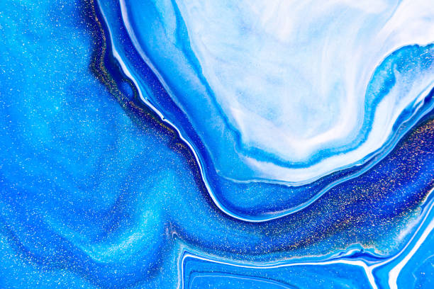 Fluid art texture. Abstract background with iridescent paint effect. Liquid acrylic artwork with flows and splashes. Mixed paints for baner or wallpaper. Blue, golden and white overflowing colors.
