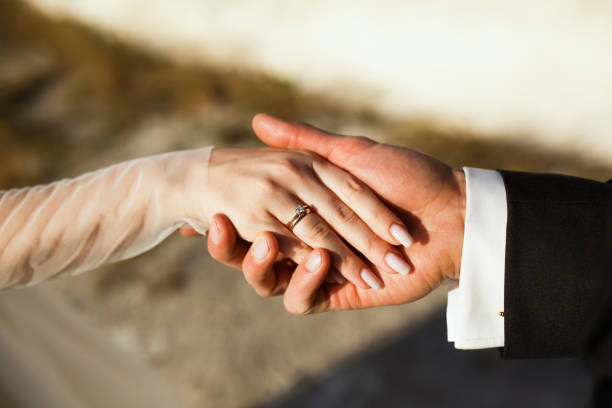 istock Couple. You can see the hands touching each other. 1227196878