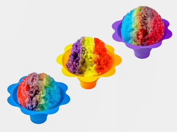 istock Three rainbow Hawaiian shave ice, shaved ice or snow cone desserts in a row against a white background. 1227197444