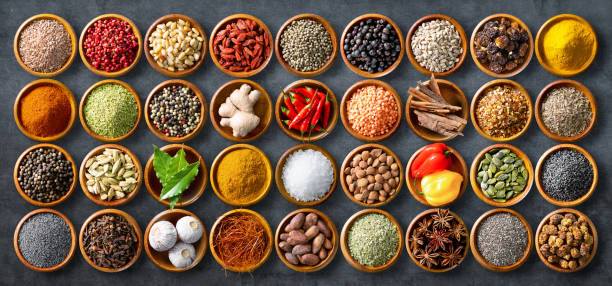 istock Colourful background from various herbs and spices for cooking in bowls 1227198289