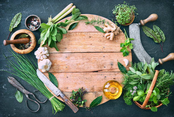 Various fresh herbs from garden with kitchen utensils on rustic table Various fresh herbs from garden with kitchen utensils on rustic table. Top view with copy space mezzaluna stock pictures, royalty-free photos & images