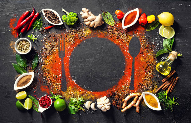 Colourful various herbs and spices for cooking on dark background