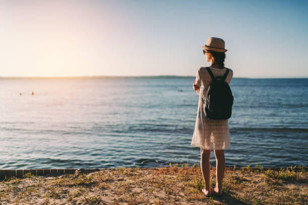 istock Girl on beach holiday feeling zen at sunset 1227199637
