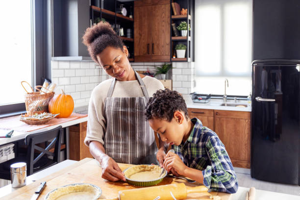 istock Woman prepare pie in the kitchen and learn his son cooking 1227199857