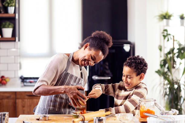 istock Woman prepare pie in the kitchen and learn his son cooking 1227199861