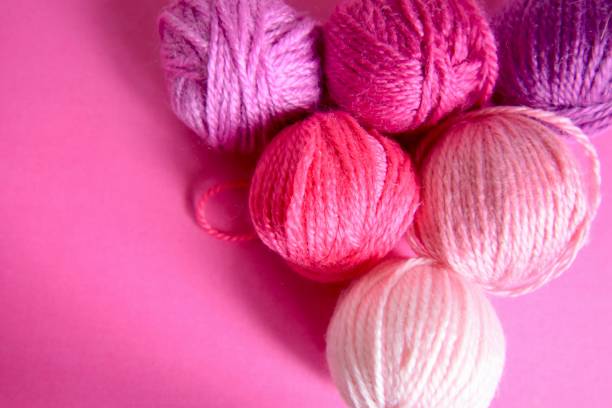 istock Balls of wool pink background 1227200320