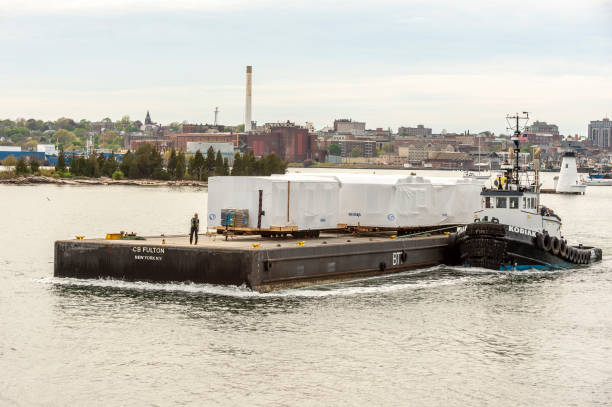 tug kodiak pushing barge loaded with modular buildings - eastman kodak company imagens e fotografias de stock