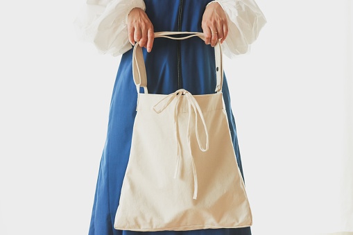 Woman holding a shopping cotton eco bag