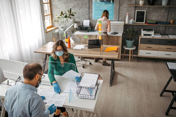 istock Bank teller discussing with customer at counter 1227206806