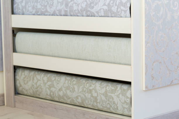 istock Shelving in the store. Fashionable multi-colored with a modern design rolls. Luxury wallpapers for interiors. 1227207138