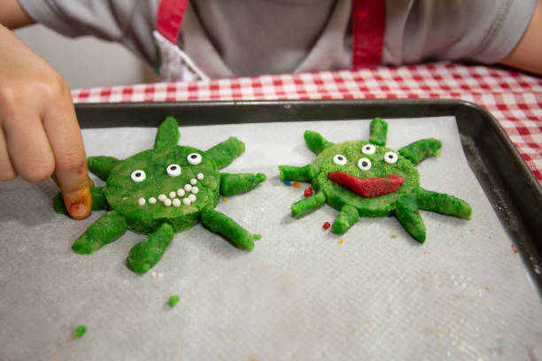 istock kids life in quarantine. coronavirus shaped cookies. 1227207445