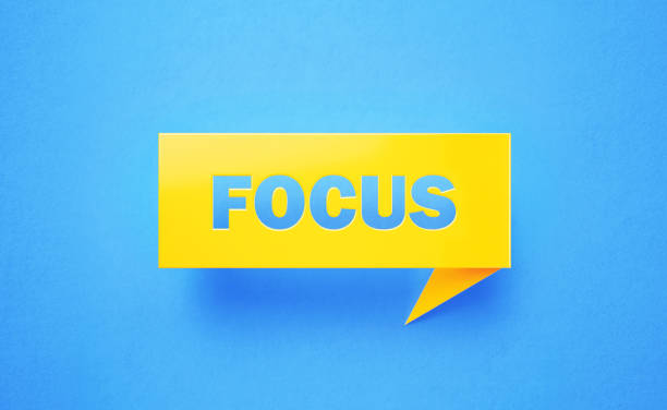 Focus written yellow chat bubble on blue background. Horizontal composition with copy space. Focus concept.