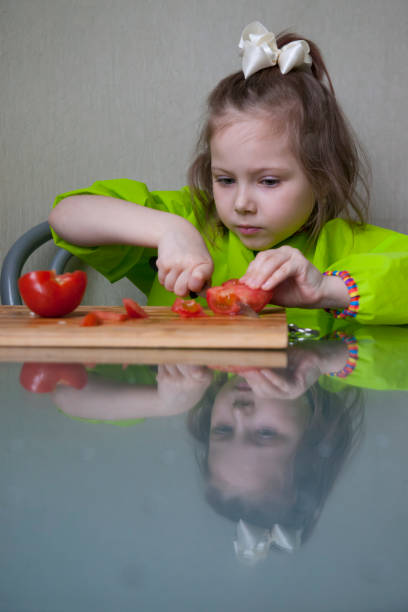 istock Five year old girl cooking a vegetable salad 1227208769