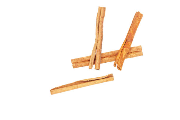 istock Three pieces of cinnamon lie on a white background, close-up. 1227209732