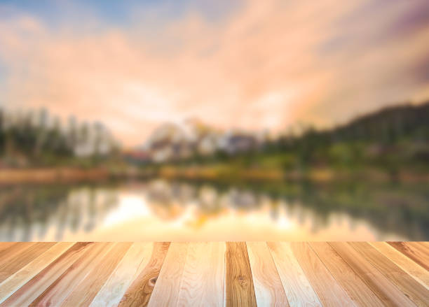 istock empty wooden deck table top Ready for product display montage with mountain when sunset background. 1227209966
