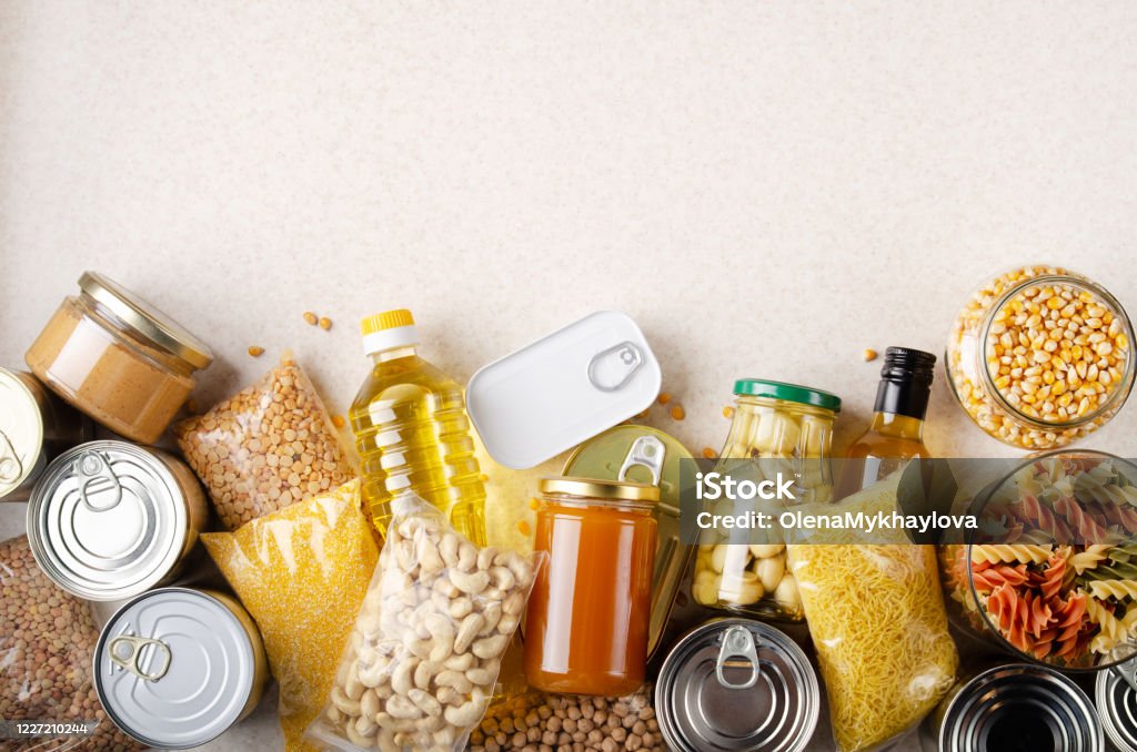 Flat lay view at kitchen table full with non-perishable foods. Spase for text Food Stock Photo