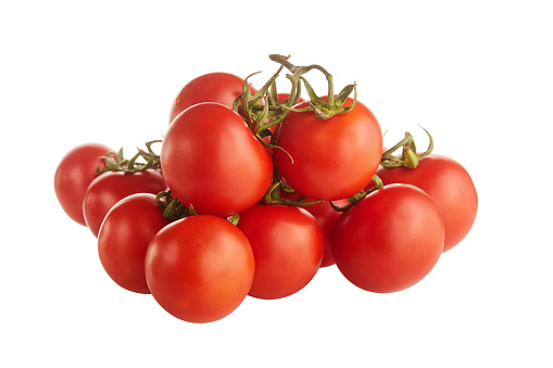 Bunch of fresh ripe and red cherry tomatoes on vine isolated on white background in the studio