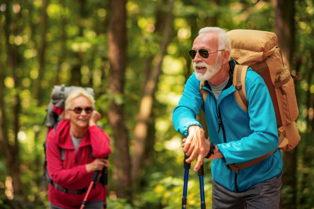istock Senior couple walking in the forest. 1227211437