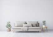 Mock up interior for minimal living room design, beige sofa and green plant on white background. Stock photo