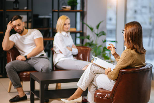 istock upset and aggrieved married couple visit professional psychologist 1227214046
