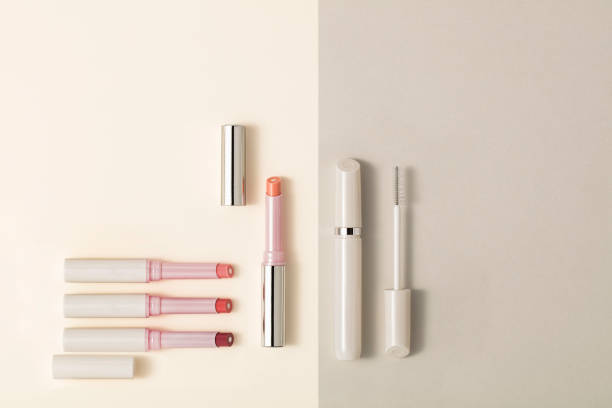 Lipsticks and mascara isolated on beige background(with clipping path)