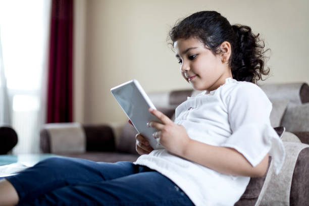 istock Little girl using digital tablet at home 1227217275