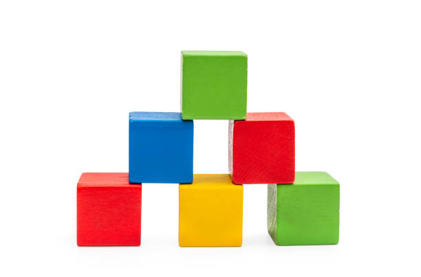 istock Pyramid from colorful wooden toy bricks on white. 1227218363