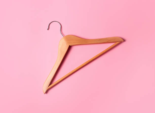 istock Wooden hanger on a pink background with place for text. 1227219847