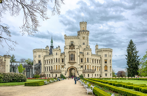 Hluboka nad Vltavou, Czech Republic - May 03, 2020: Gothic ancient castle Hluboka nad Vltavou in the south of the Czech Republic. Schwarzenberg noble residence and spring green garden, a popular tourist attraction